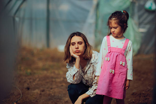 Portrait of mother and young daughter in forest in autumn, Rio Grande Valley State Park, Albuquerque, New Mexico