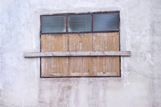 istock Closed old wood window on white concrete background 2205312754