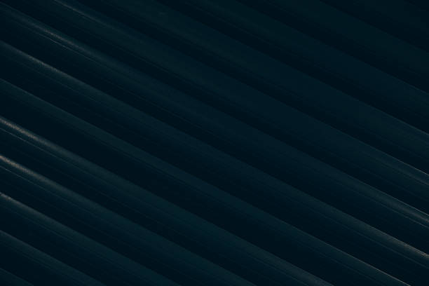 Detailed image of corrugated paneling with dark navy blue color that appears to be metal or plastic. The lines and texture create depth with a uniform, sleek design.