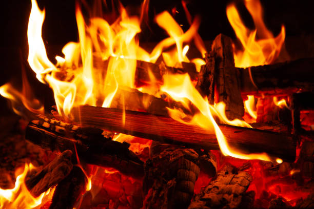 istock burning wood in the fireplace 2205319284
