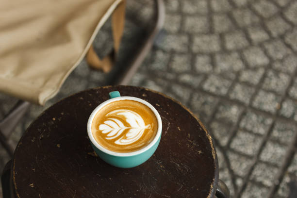 istock Hot latte coffee is serving with turquoise coffee cup. 2205319934