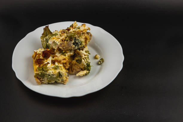 A close-up view of a freshly baked pasta casserole in a glass dish, featuring a golden, bubbling cheese crust. The dish is shown inside the oven, highlighting its crispy, appetizing top layer and creamy interior. Perfect for illustrating home cooking, comfort food, baking, or family meals.