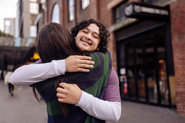 istock Interracial couple hugging on a street 2205322318