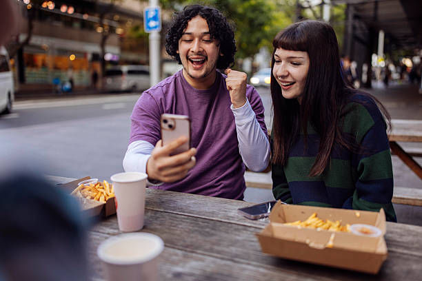 istock Teenagers with cellphone celebrating vicotory 2205323361