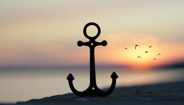 istock iron anchor on wooden pier in sunset light 2205325589