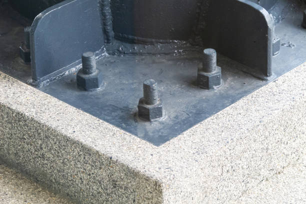 istock Close-Up of Industrial Bolt Fasteners on Concrete Base Structure 2205325946