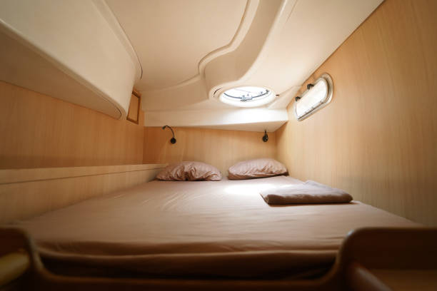 istock Cozy bed on a voyage boat with a window overhead with natural light 2205326248
