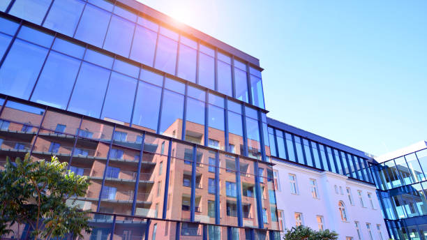 istock A renovation residential building and an adjacent modern office building. 2205327930