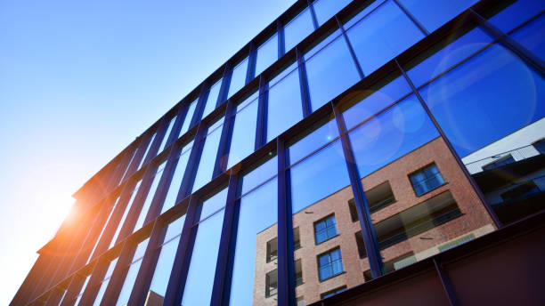 istock Exterior of modern building with many windows against blue sky, low angle view. 2205327961