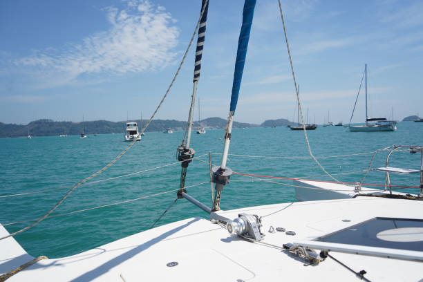 A white voyage boat featuring a steering wheel floating in the water.