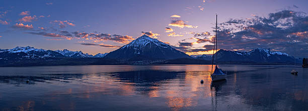 istock Sunset over the Niesen Mountain (socalled Swiss Pyramid) with its shape reflection 2205330897