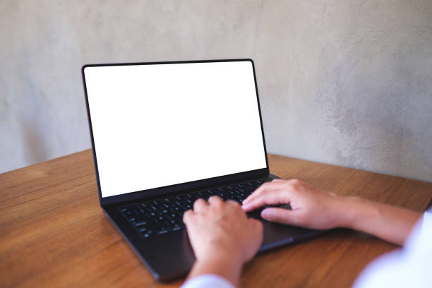 istock Mockup image of a woman using and typing on computer laptop with blank desktop screen 2205333571