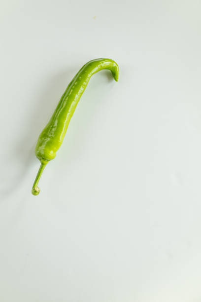Horizontal image of heap of moti hari mirch or michi or food vegetable big green chilli Anaheim Pepper covering full frame green vibrant bright  background, denoting healthy vegetarian food, a nutrition source of, Vitamin C, fiber, antioxidants