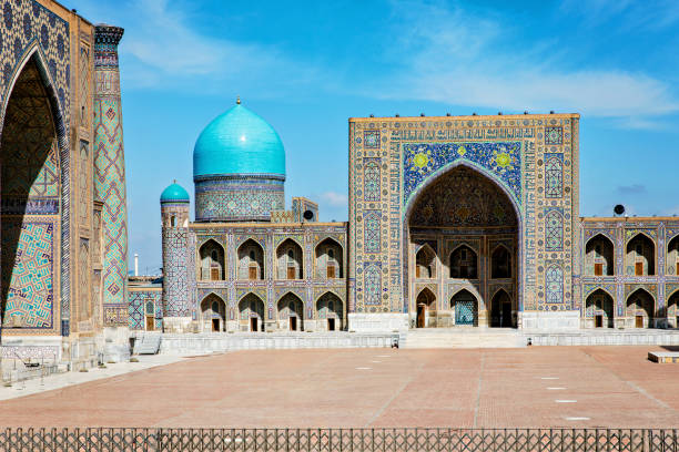 istock Registan Square in Samarkand, Uzbekistan, a historic architectural ensemble featuring three stunning madrasas with intricate mosaic designs, domes, and minarets under a bright blue sky 2205339340