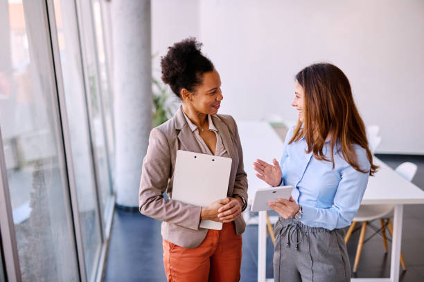 istock Two businesswomen discussing work in modern office 2205342056