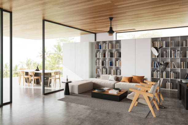 istock Modern living room with bookshelf and dining area. 3D Rendering 2205342534