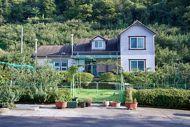 Gurye County, South Korea - October 3, 2021: A cozy rural home surrounded by a lush garden and fruit orchards, blending modern and traditional countryside living in a peaceful natural setting.