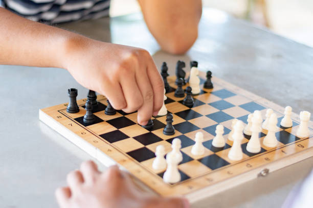 istock Playing chess games on mini wooden chessboard 2205345576