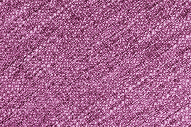 Pink Jacquard fabric with large loose diagonal woven, coarse weave texture upholstery cloth. Textile background, furniture textile material, wallpaper, backdrop. Cloth structure close up, macro.