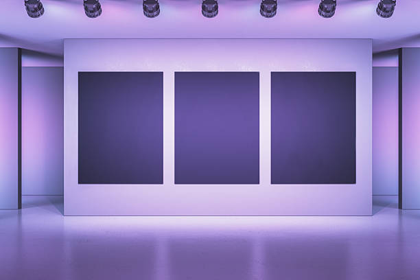 istock Modern exhibition gallery with three blank dark frames on a white wall under spotlights. 3D Rendering 2205348704