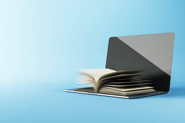 istock Open book emerging from a laptop screen on a blue background. Concept of online education, digital learning, and modern technology in education. 3D Rendering 2205348845