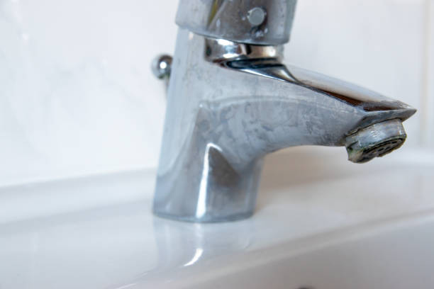 istock Metal tap with much water  limescale water in bathroom. 2205349977