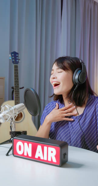 istock woman singing and live broadcasting 2205359474