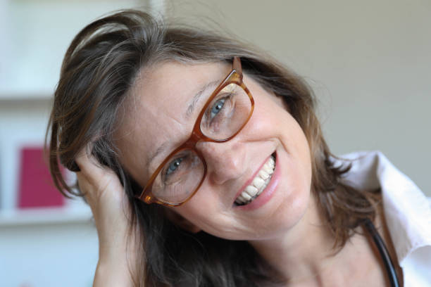 A beautiful middle-aged female doctor with glasses, close-up.