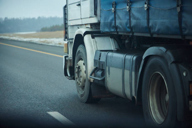 istock Truck wheels while driving, close-up 2205360400