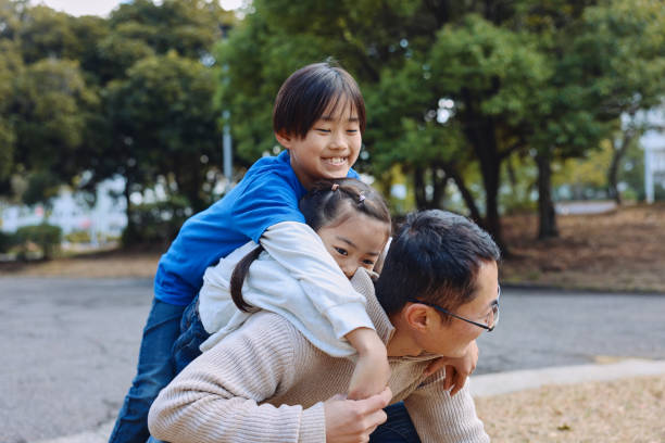 istock Asian Dad Interact With His Child Outdoors 2205361680
