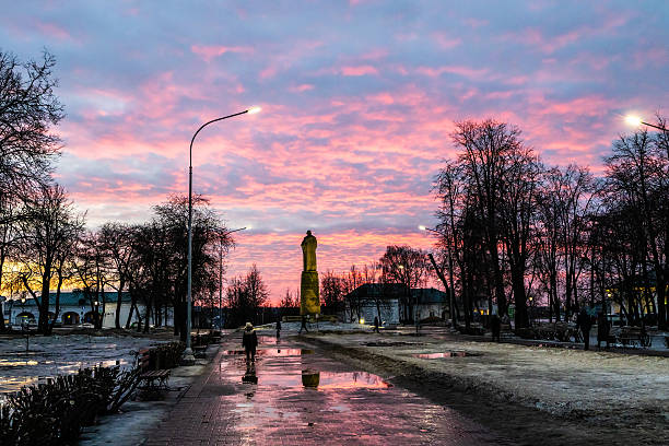 wet path in park on Susanin square in Kostroma city on winter dusk
