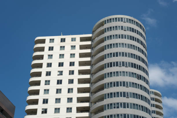 Tall building with cloudy blue sky.