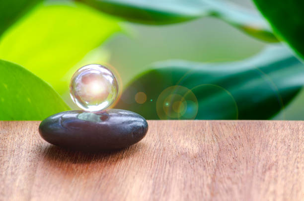 istock Black Zen stone with customizable space for text or message. Shining glass marble background 2205366124