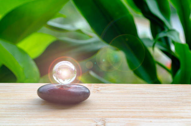 istock Black Zen stone with customizable space for text or message. Shining glass marble background. 2205366125