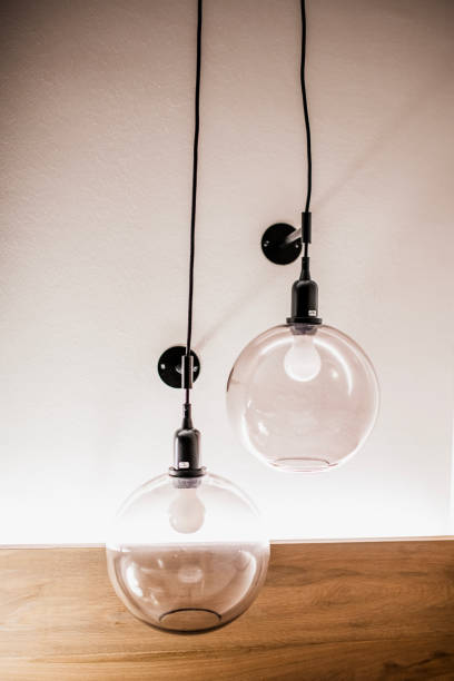 istock Modern Glass Pendant Lights with Warm Glow in a Cozy Interior 2205366411