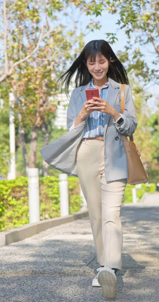 istock Asian businesswoman walking commute 2205366667