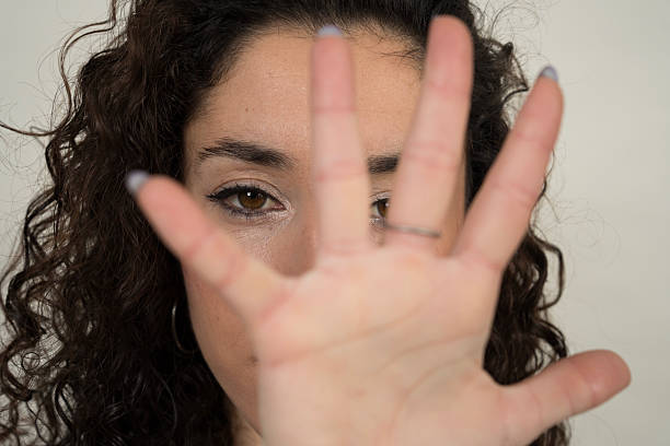 istock Young woman making stop sign with hand 2205370732