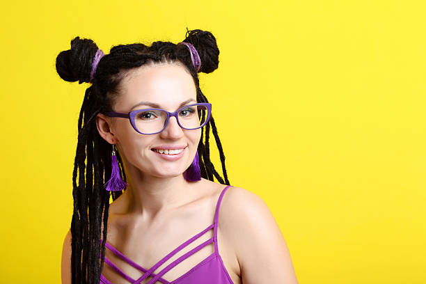 istock Young woman with dreadlocks on yellow background 2205372149