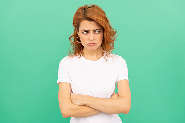 istock portrait of redhead lady on blue background. express negative emotions 2205374052