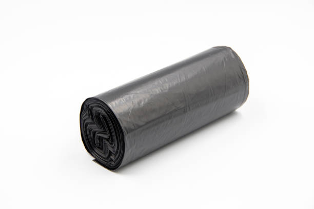 istock Black plastic garbage bags on white background, Roll of garbage bags on white background 2205374270