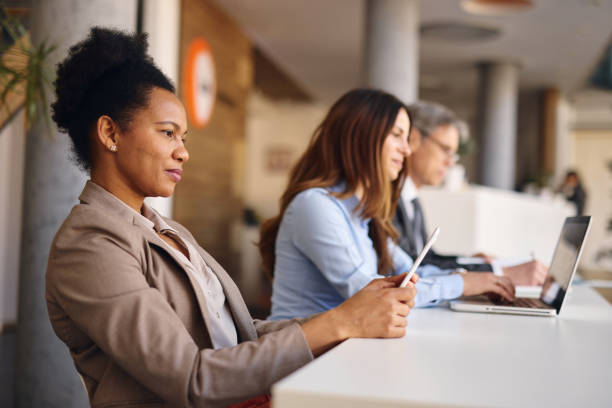 istock Focused business team working in modern office using digital tablet and laptop 2205375063