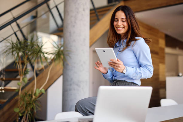 istock Young businesswoman using digital tablet in modern office 2205375140