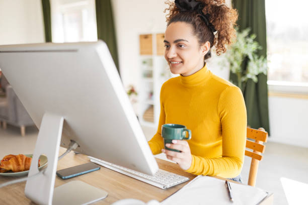 istock Freelancer Woman Typing on Laptop at Home 2205376457