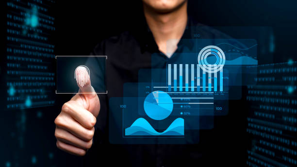 istock A person uses biometric authentication with a fingerprint scan, overlaid with futuristic digital data visualizations, including graphs and analytics in a high-tech interface. 2205376628
