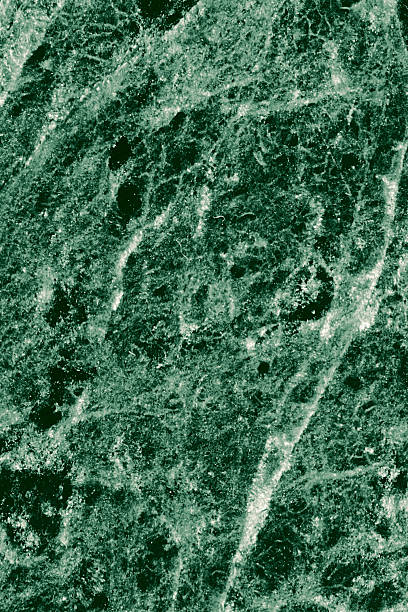istock Real closeup of dark green marble stone texture surface background. Design pattern with high resolution for luxury home decoration. Abstract matt slab rock material. Front view of natural tiles stone surface. 2205377055