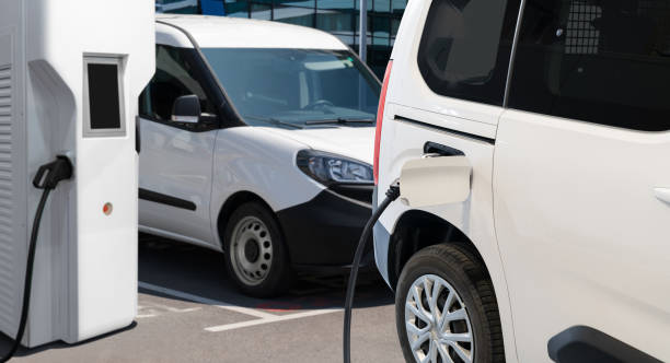 istock Electric delivery van with charging station 2205378103