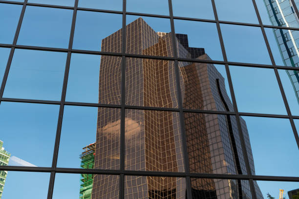 Background architecture with skyscraper reflection. Modern glass background. Glass exterior background. Architecture. Building exterior architecture. Building background. Glass building window.