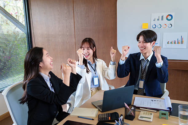 istock Excited startup team celebrating business success after achieving project milestones, fostering teamwork and motivation in a modern office environment focused on innovation and growth 2205379149