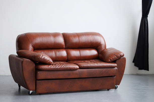istock Brown leather sofa in minimalist interior on white background 2205385622