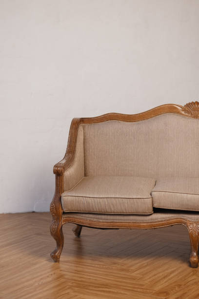 istock Vintage Wooden Sofa with Beige Upholstery 2205385885